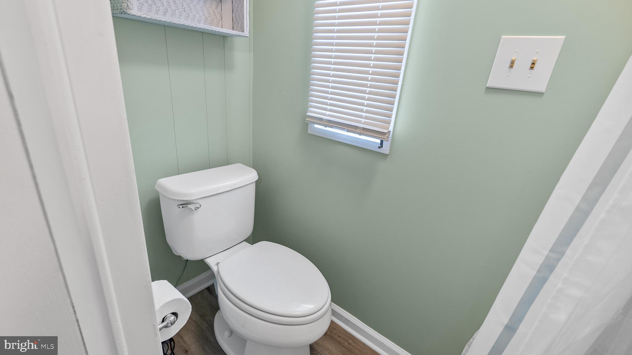 13324 Nantucket Road Ocean City, MD 21842 - Photo 10 of 45 a white toilet sitting next to a small window