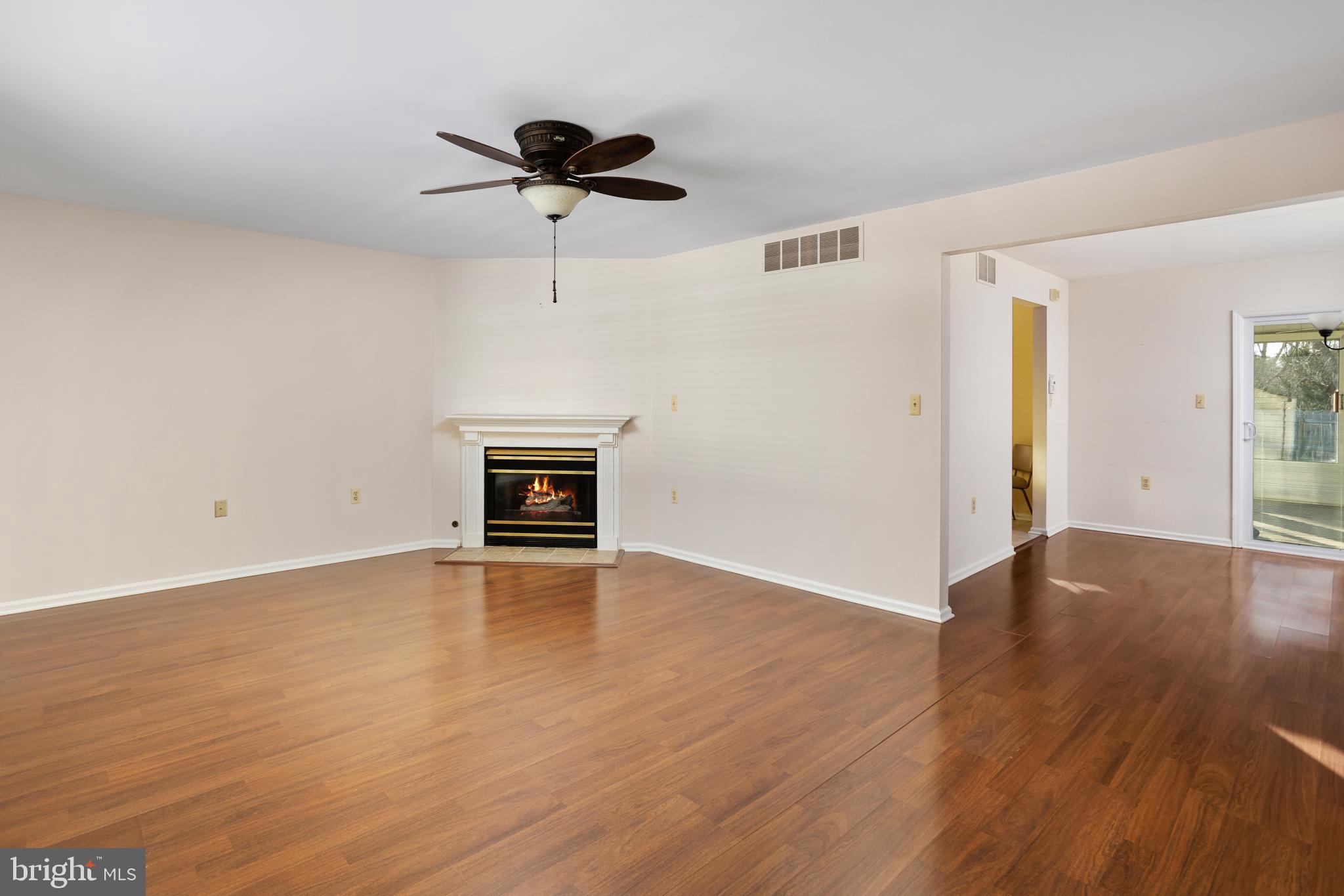 3 Escambia Trail Browns Mills, NJ 08015 - Photo 6 of 30 an empty room with wooden floor ceiling fan and windows