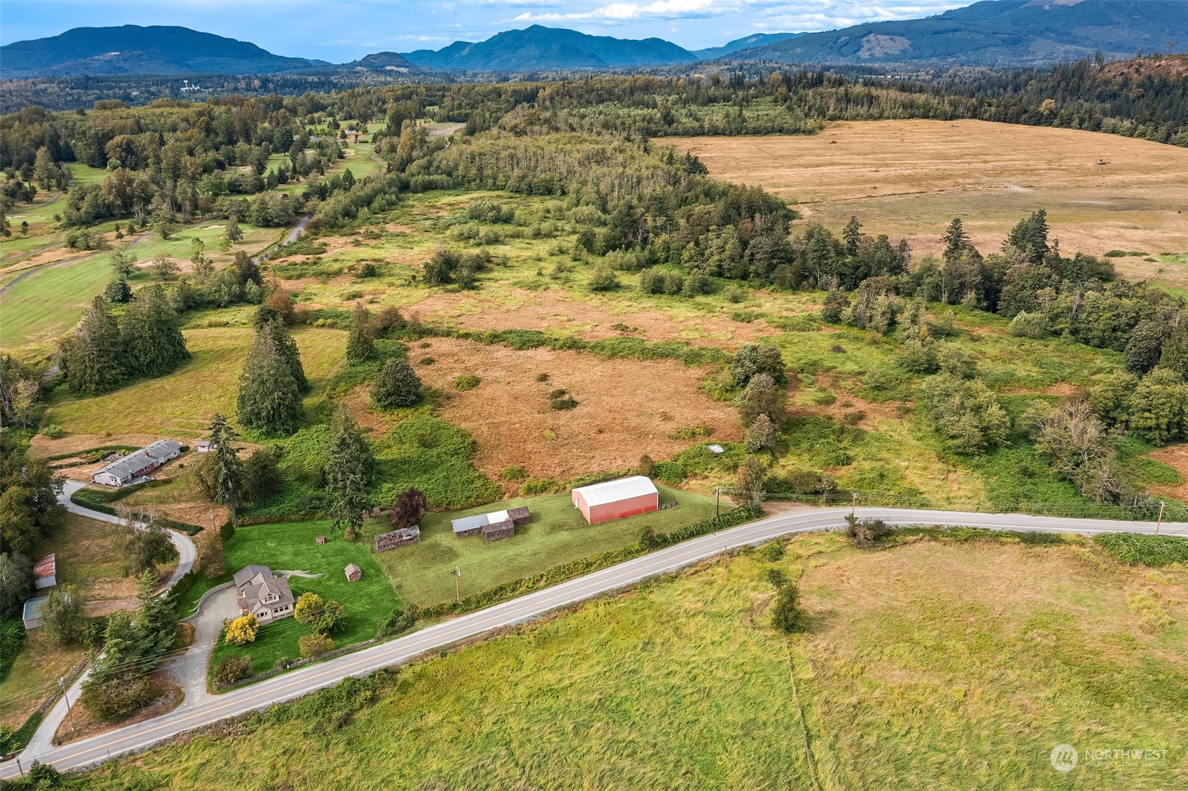 19589 Kelleher Road Burlington, WA 98233 - Photo 2 of 39 a view of a lake with mountains in the background
