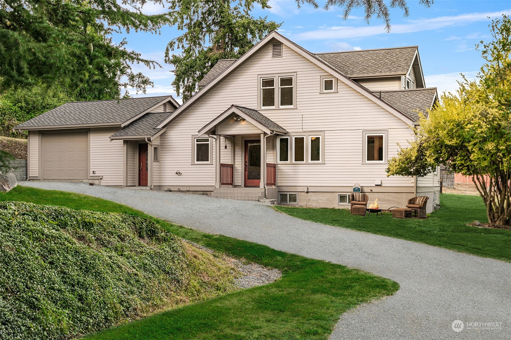 19589 Kelleher Road Burlington, WA 98233 - Photo 4 of 39 a view of a white house next to a yard with big trees