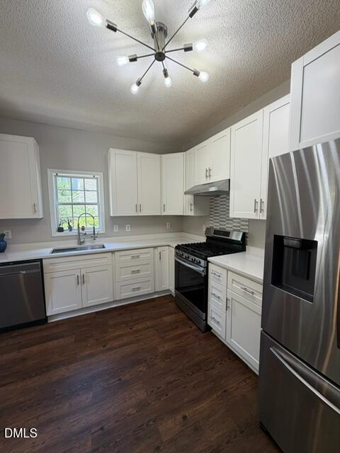 6016 River Lake Circle Raleigh, NC 27604 - Photo 11 of 20 a kitchen with granite countertop a refrigerator oven a sink dishwasher and white cabinets with wooden floor