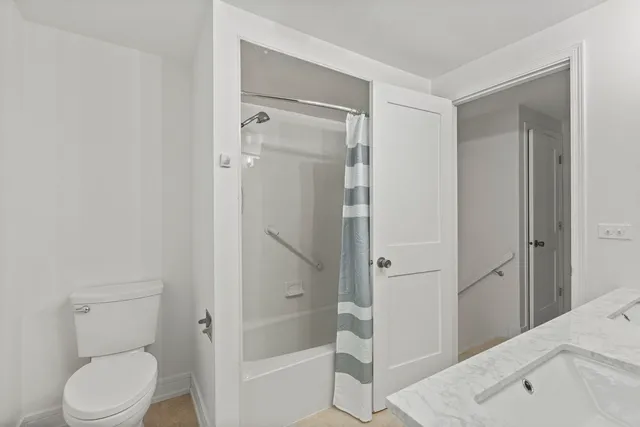 a bathroom with a shower and a toilet