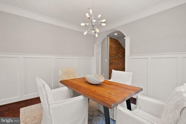 a front view of a building with sitting area