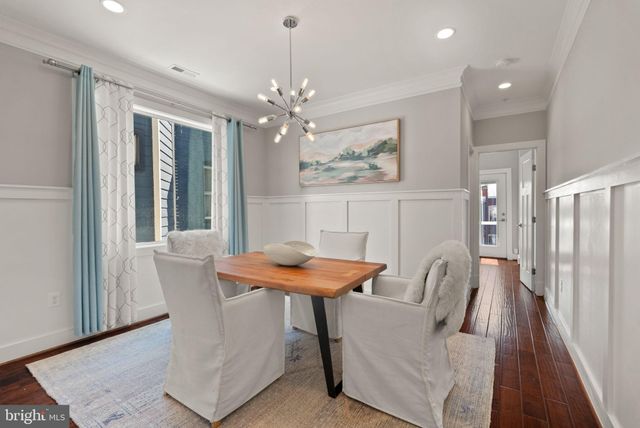 a view of a dining room with furniture and a chandelier