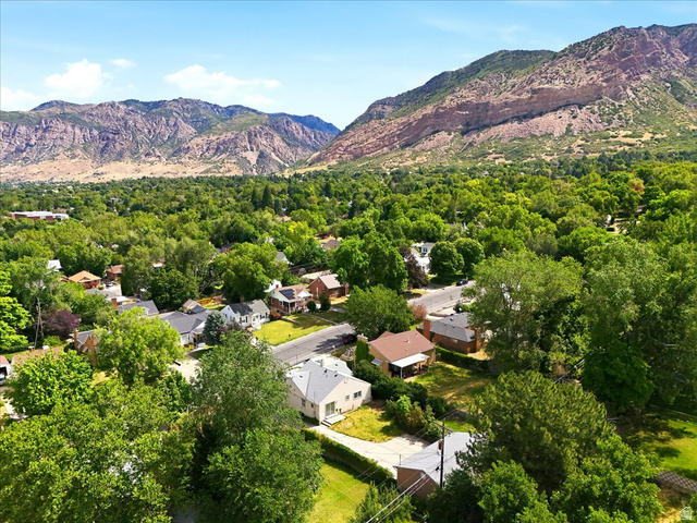 1341 29th Street Ogden, UT 84403 - Photo 35 of 37 Aerial perspective showcasing a residential neighborhood with abundant mature trees and mountainous terrain
