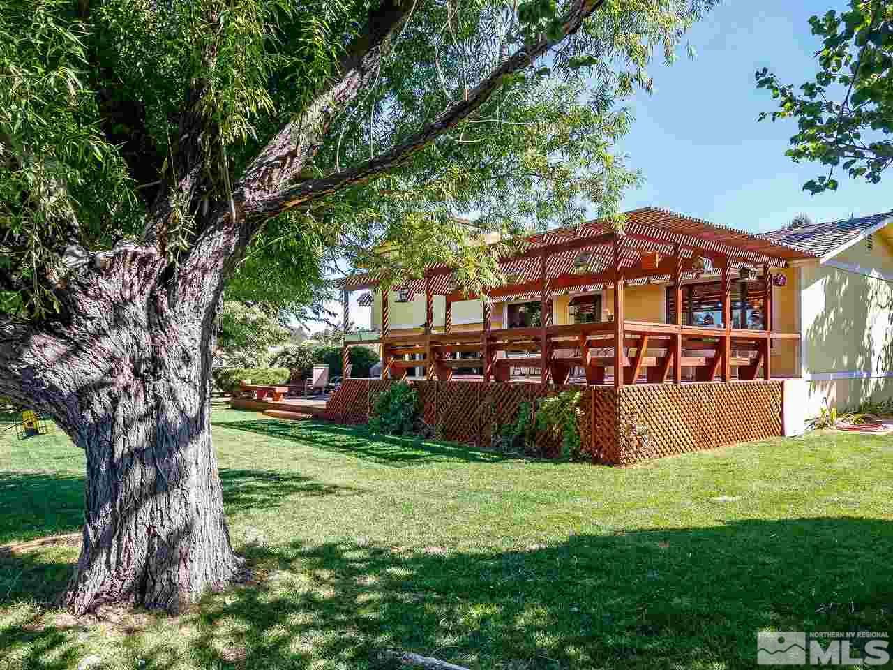 3258 Bottom Road Fallon, NV 89406 - Photo 23 of 25 a front view of a house with garden and trees