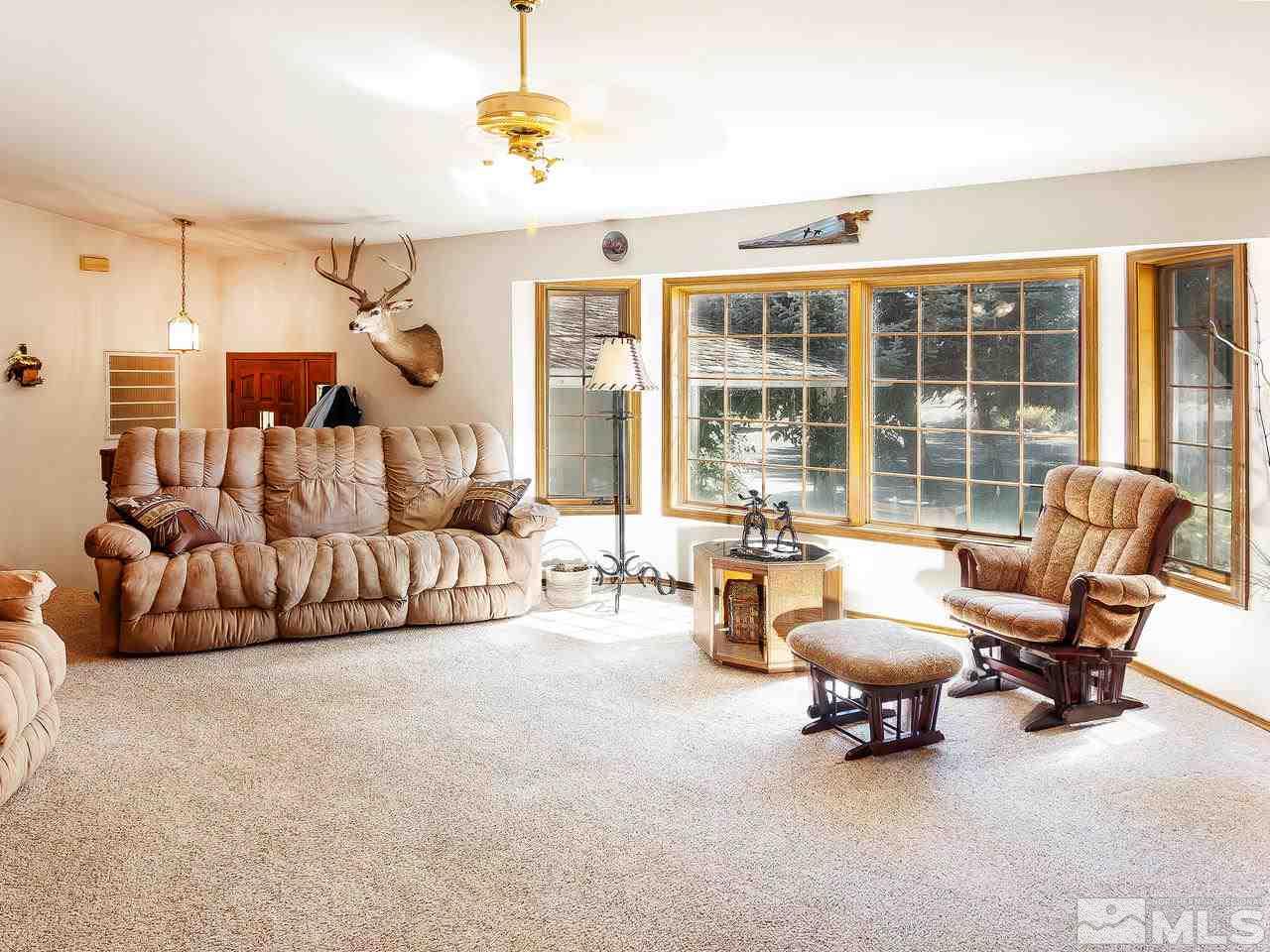 3258 Bottom Road Fallon, NV 89406 - Photo 7 of 25 a living room with furniture gym equipment and a large window