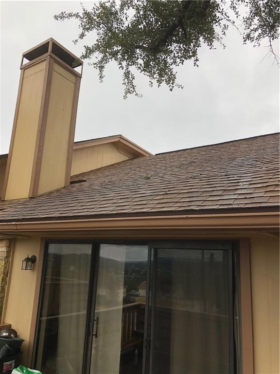 1 Oaks Place Lago Vista, TX 78645 - Photo 8 of 13 Exterior view of a shingled roof and a chimney