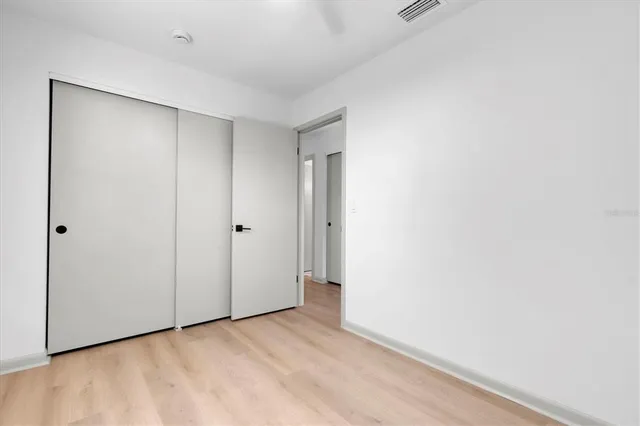 a bedroom with bed and a potted plant