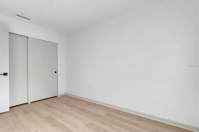 a bedroom with bed and a window