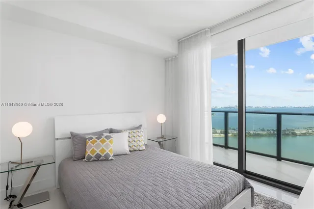 a bedroom with a bed and glass door