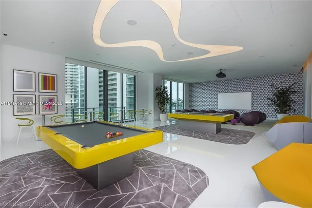 a living room with pool tables and a pool