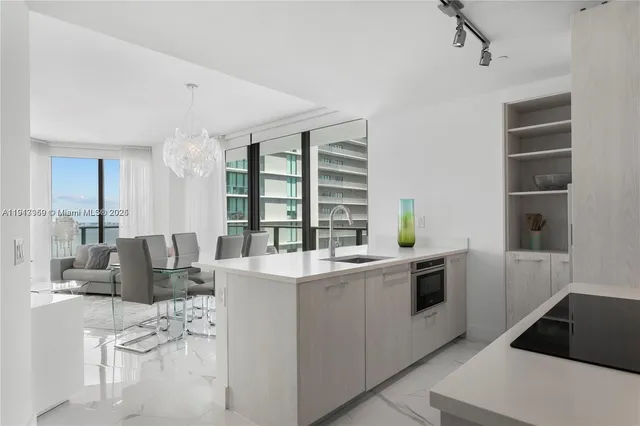 a kitchen with a sink and a stove top oven