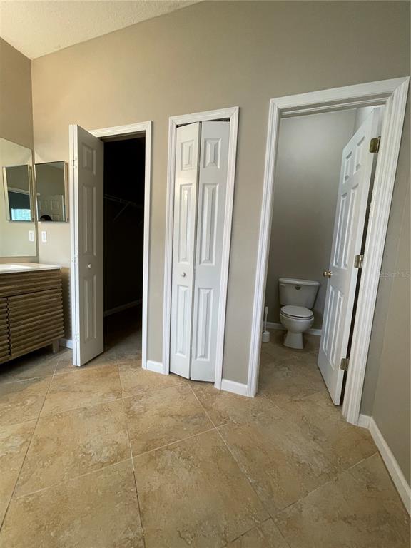 4939 Woodmere Road Land O Lakes, FL 34639 - Photo 12 of 43 a view of a room with a furniture and a bathroom
