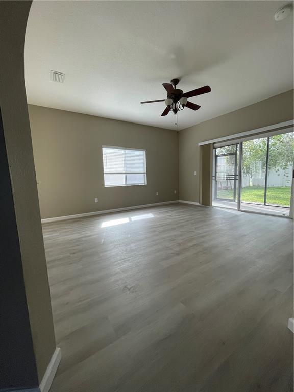 4939 Woodmere Road Land O Lakes, FL 34639 - Photo 14 of 43 wooden floor in an empty room with a window