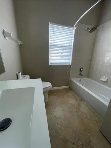 a bathroom with a bathtub a sink and a toilet