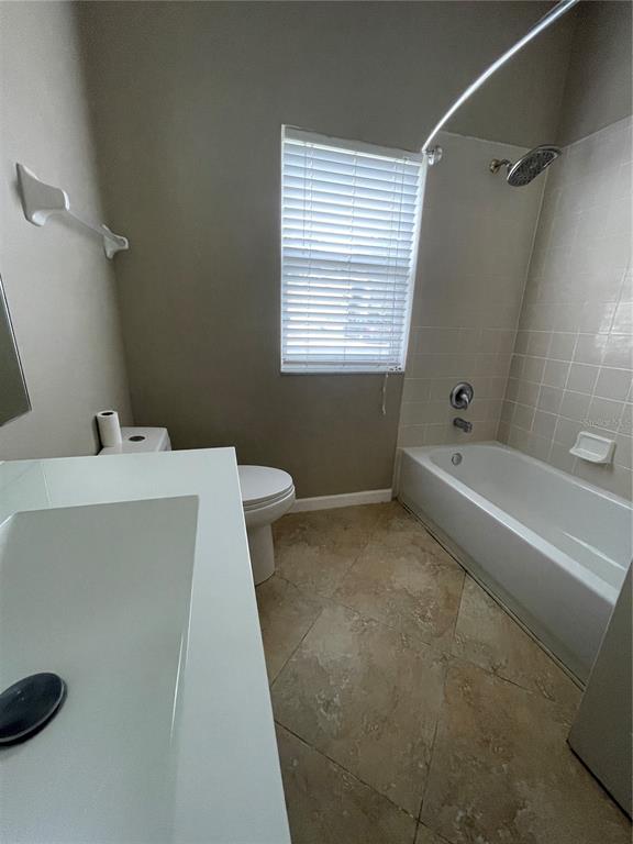 4939 Woodmere Road Land O Lakes, FL 34639 - Photo 19 of 43 a bathroom with a bathtub a sink and a toilet