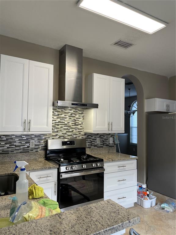 4939 Woodmere Road Land O Lakes, FL 34639 - Photo 2 of 43 a kitchen with a stove and a cabinets
