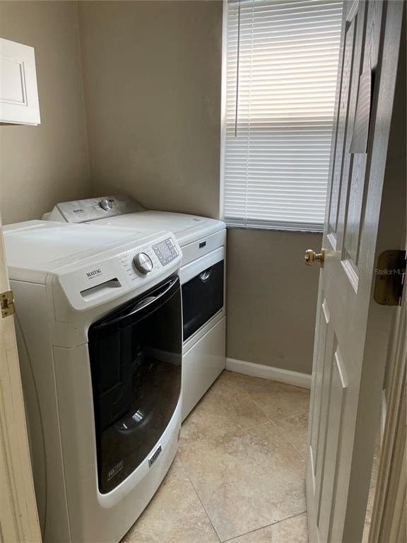4939 Woodmere Road Land O Lakes, FL 34639 - Photo 22 of 43 a utility room with washer and dryer