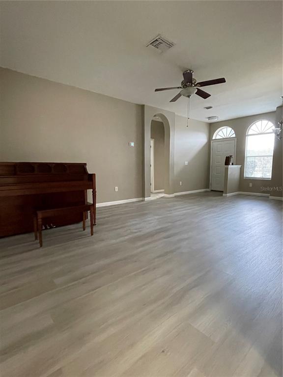 4939 Woodmere Road Land O Lakes, FL 34639 - Photo 25 of 43 a view of a livingroom with furniture and a ceiling fan
