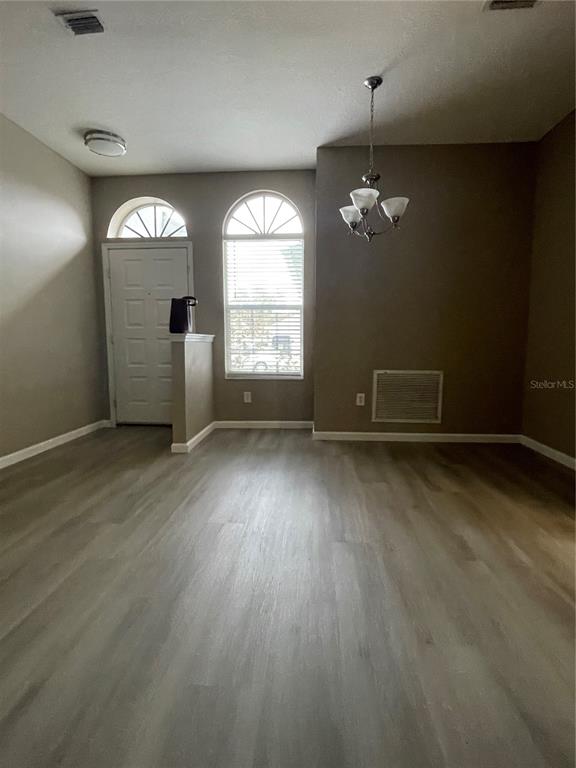 4939 Woodmere Road Land O Lakes, FL 34639 - Photo 27 of 43 an empty room with wooden floor and windows
