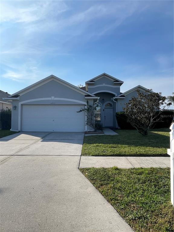 4939 Woodmere Road Land O Lakes, FL 34639 - Photo 30 of 43 front view of a house with a yard