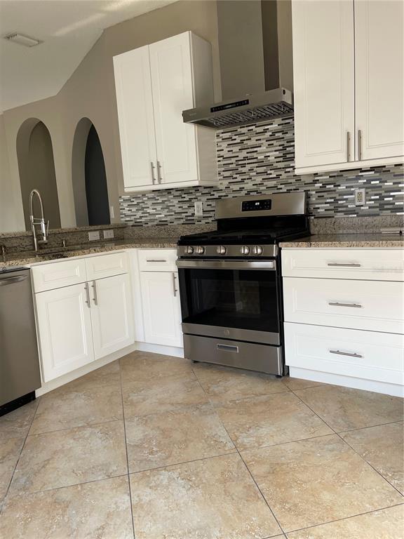 4939 Woodmere Road Land O Lakes, FL 34639 - Photo 3 of 43 a kitchen with granite countertop a stove sink and cabinets