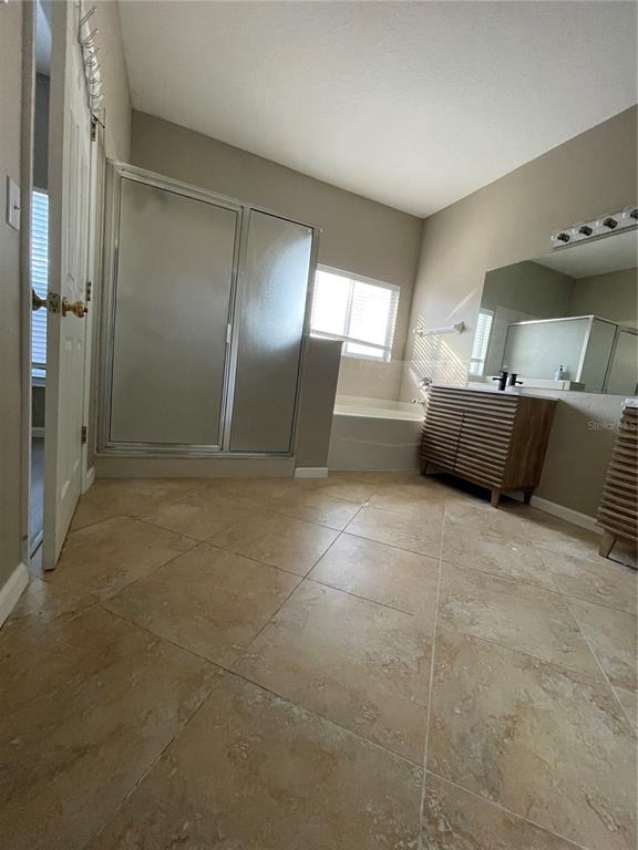 4939 Woodmere Road Land O Lakes, FL 34639 - Photo 36 of 43 a large bathroom with a tub and shower