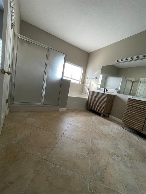 4939 Woodmere Road Land O Lakes, FL 34639 - Photo 37 of 43 a large bathroom with a large tub and shower