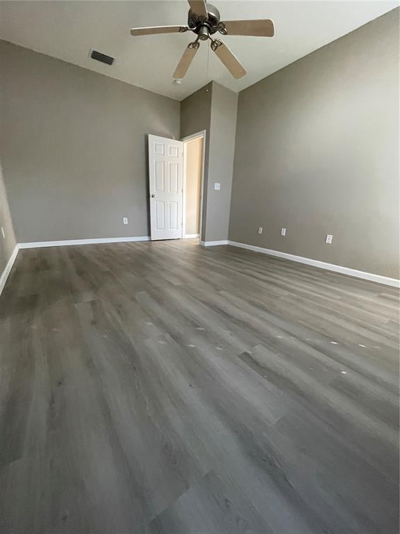 4939 Woodmere Road Land O Lakes, FL 34639 - Photo 39 of 43 an empty room with a ceiling fan and window