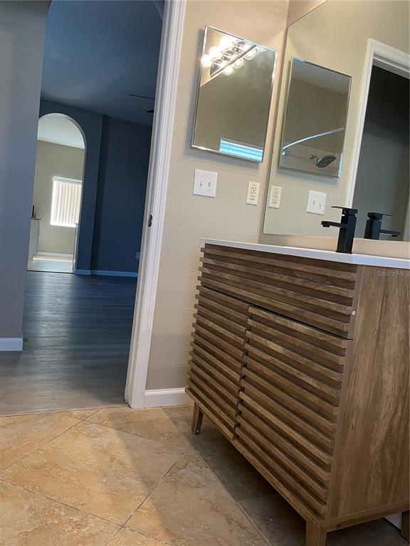 4939 Woodmere Road Land O Lakes, FL 34639 - Photo 41 of 43 a view of a hallway with entryway wooden floor and cabinet