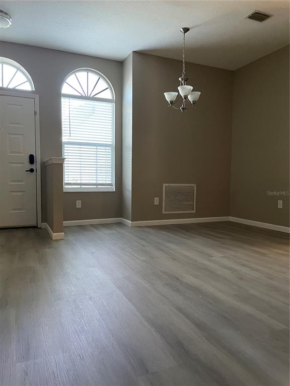 4939 Woodmere Road Land O Lakes, FL 34639 - Photo 43 of 43 an empty room with wooden floor and windows