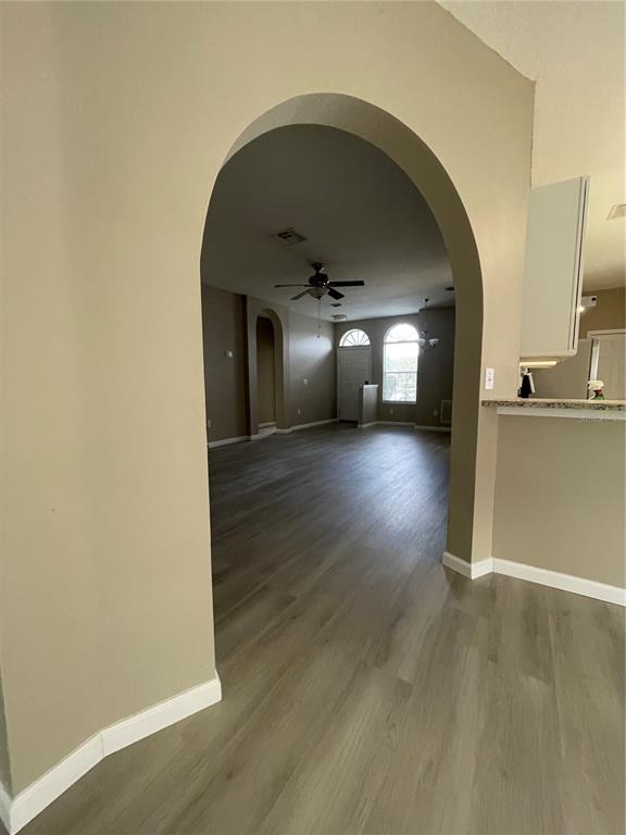 4939 Woodmere Road Land O Lakes, FL 34639 - Photo 9 of 43 a view of a hallway with wooden floor
