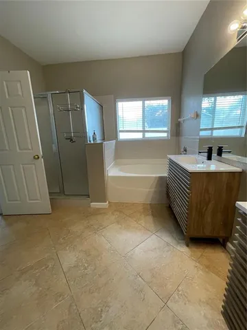 a spacious bathroom with a bathtub and a shower