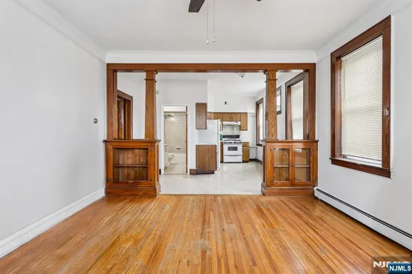 wooden floor in an empty room with a window
