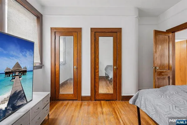 a bedroom with a bed and a mirror