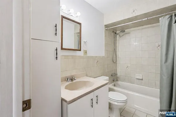 a bathroom with a sink toilet vanity and shower