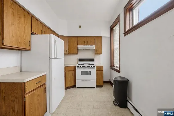 a kitchen with stainless steel appliances granite countertop a refrigerator and a stove