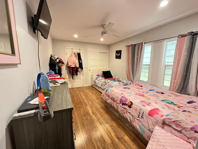 a bed room with a bed tv and a window