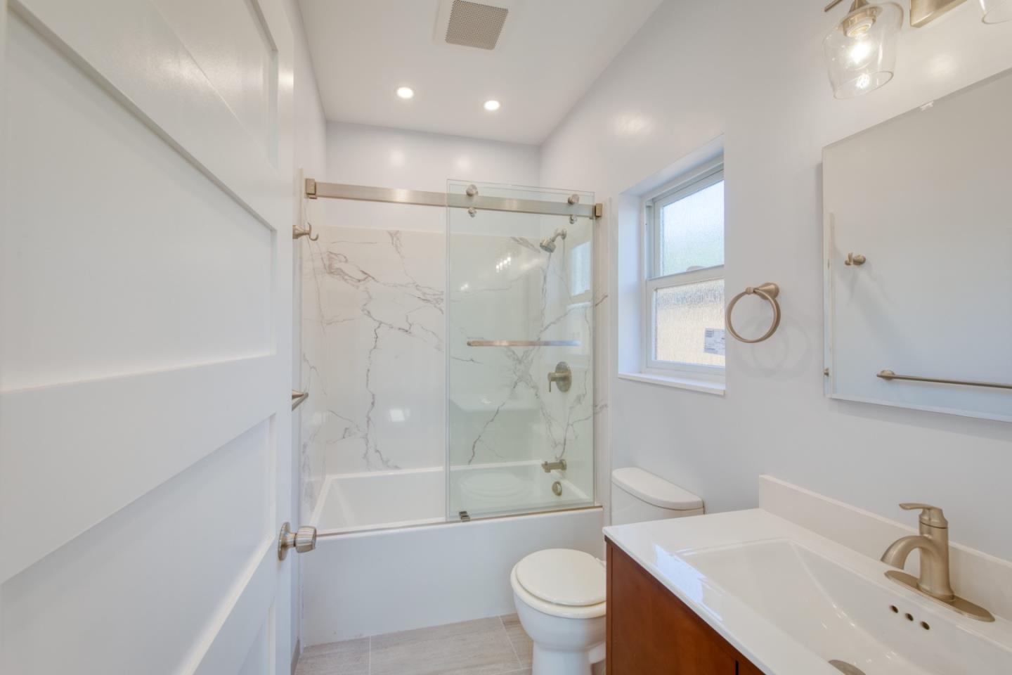 1439 38th Avenue Oakland, CA 94601 - Photo 6 of 15 a bathroom with a sink a toilet and shower
