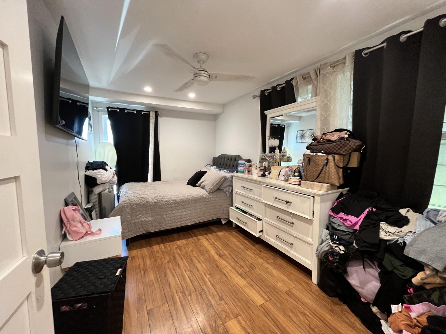 1439 38th Avenue Oakland, CA 94601 - Photo 10 of 15 a bedroom with a bed and flat screen tv