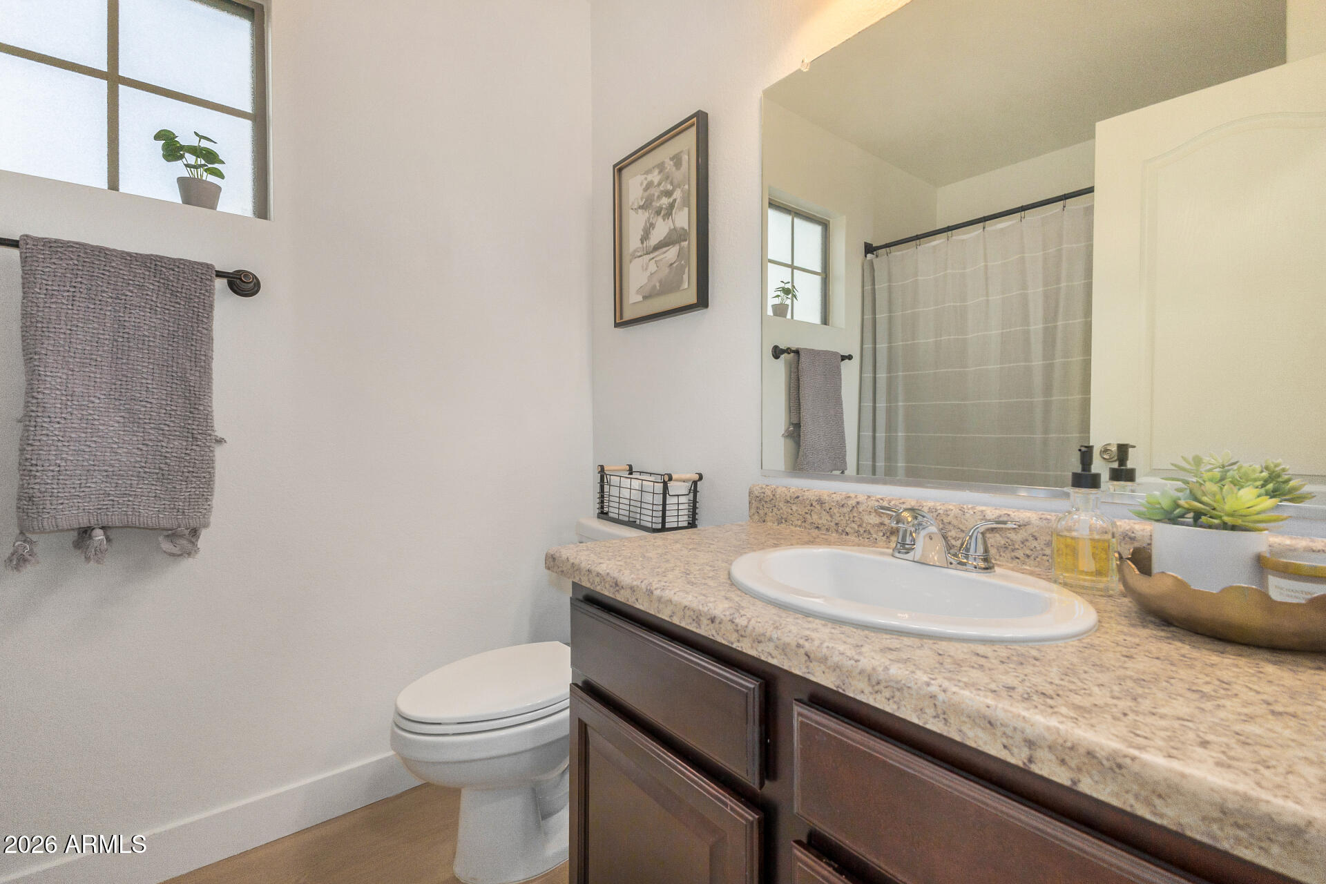 2725 East Mine Creek Road, Unit 1101 Phoenix, AZ 85024 - Photo 24 of 43 a bathroom with a granite countertop sink a toilet and a mirror