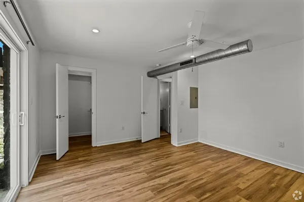a view of a big room with wooden floor and closet