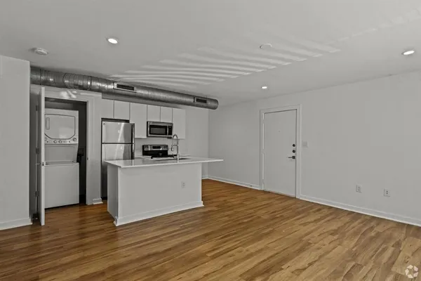 a kitchen with stainless steel appliances a refrigerator and a stove top oven
