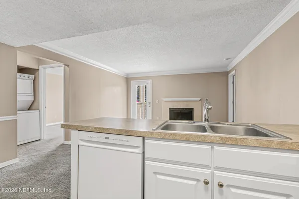 a view of a kitchen counter space and a fireplace