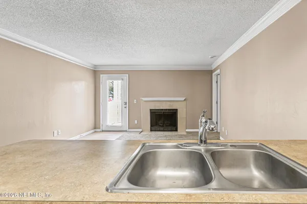 a view of kitchen sink with granite countertop