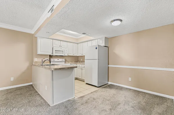 a kitchen with a sink cabinets and refrigerator