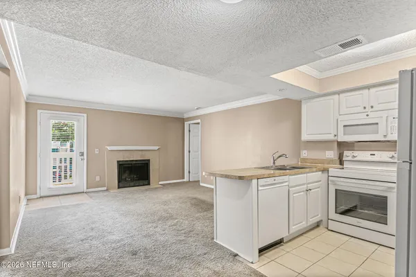 a kitchen with a sink stove and cabinets