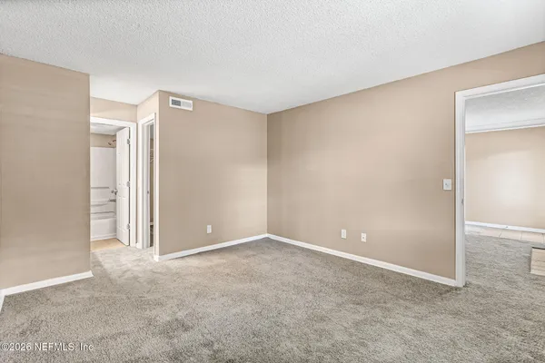 an empty room with windows and closet