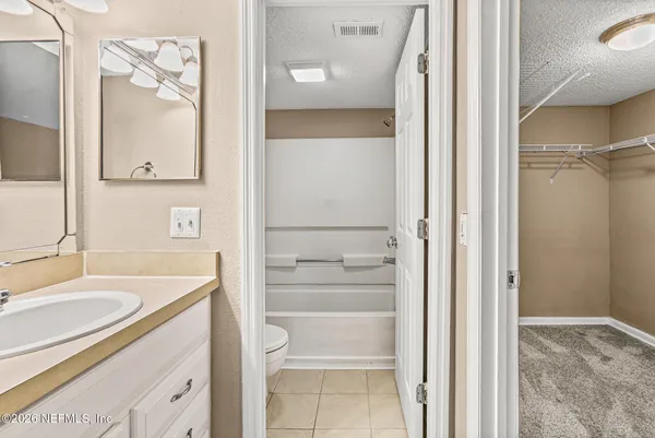 a bathroom with a sink vanity and a mirror